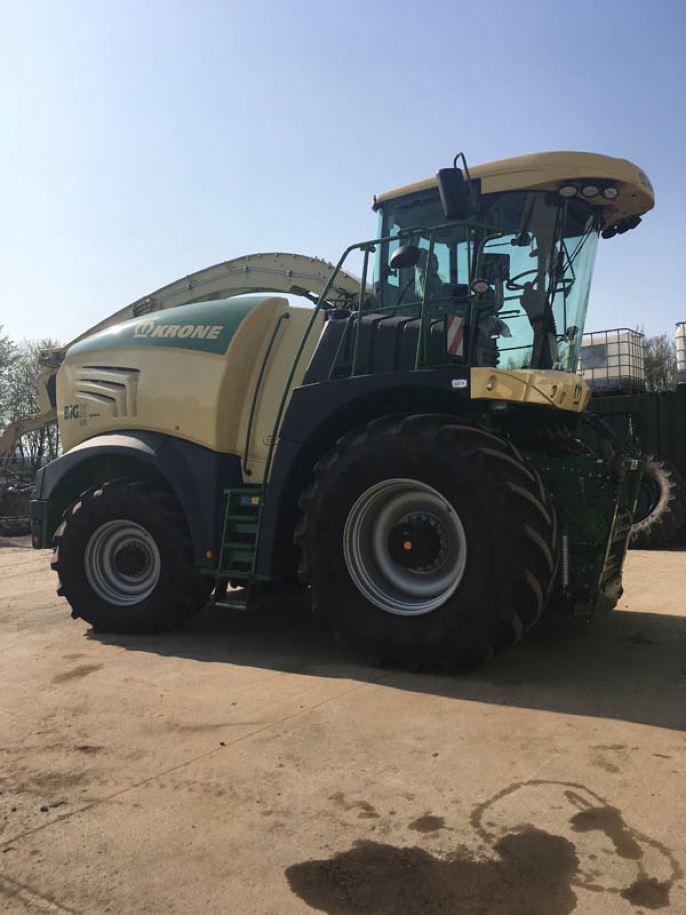 A Krone forage harvester parked on the yard.