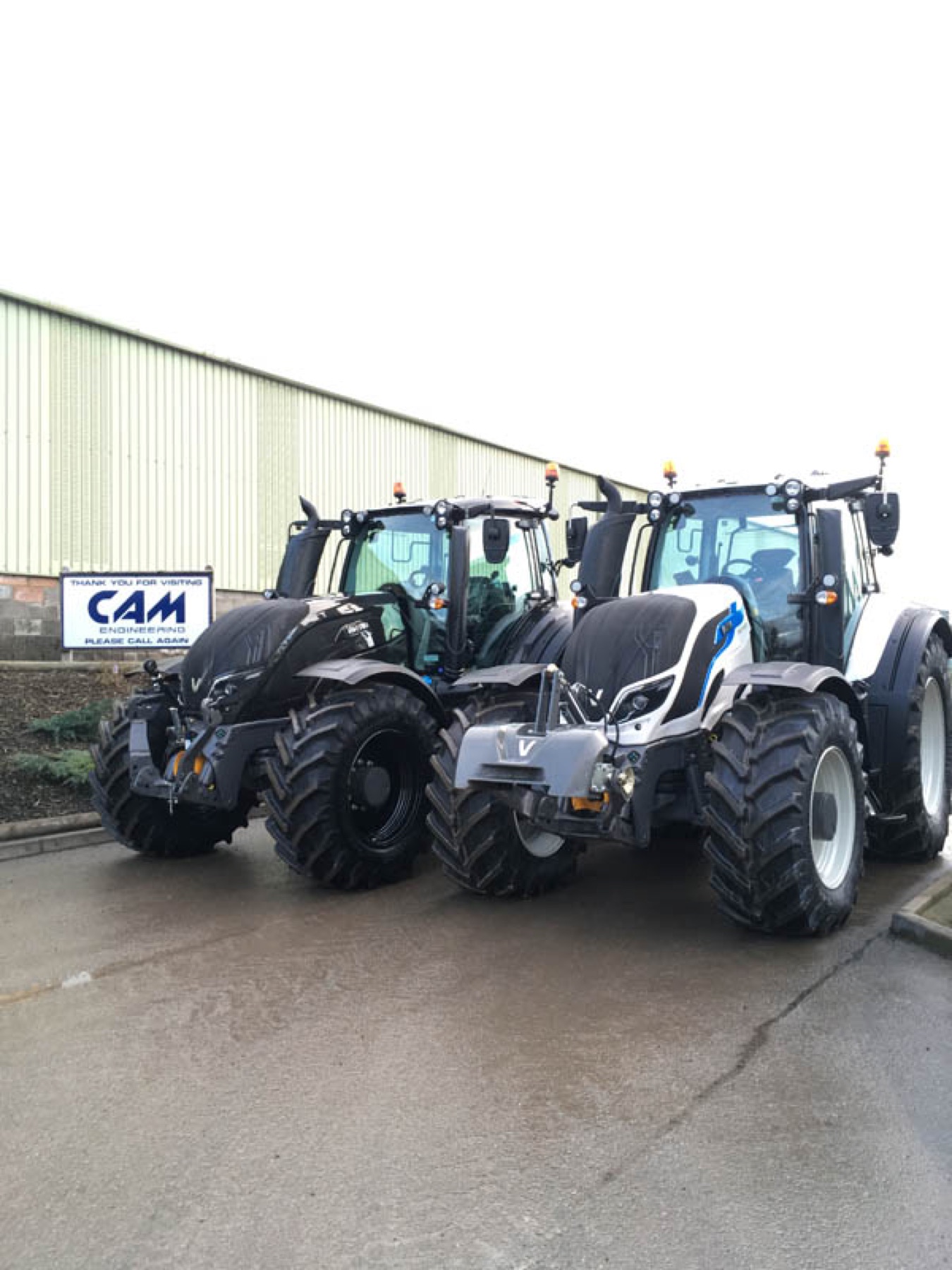 Two Valtra tractors parked outside the shed at CAM Engineering.